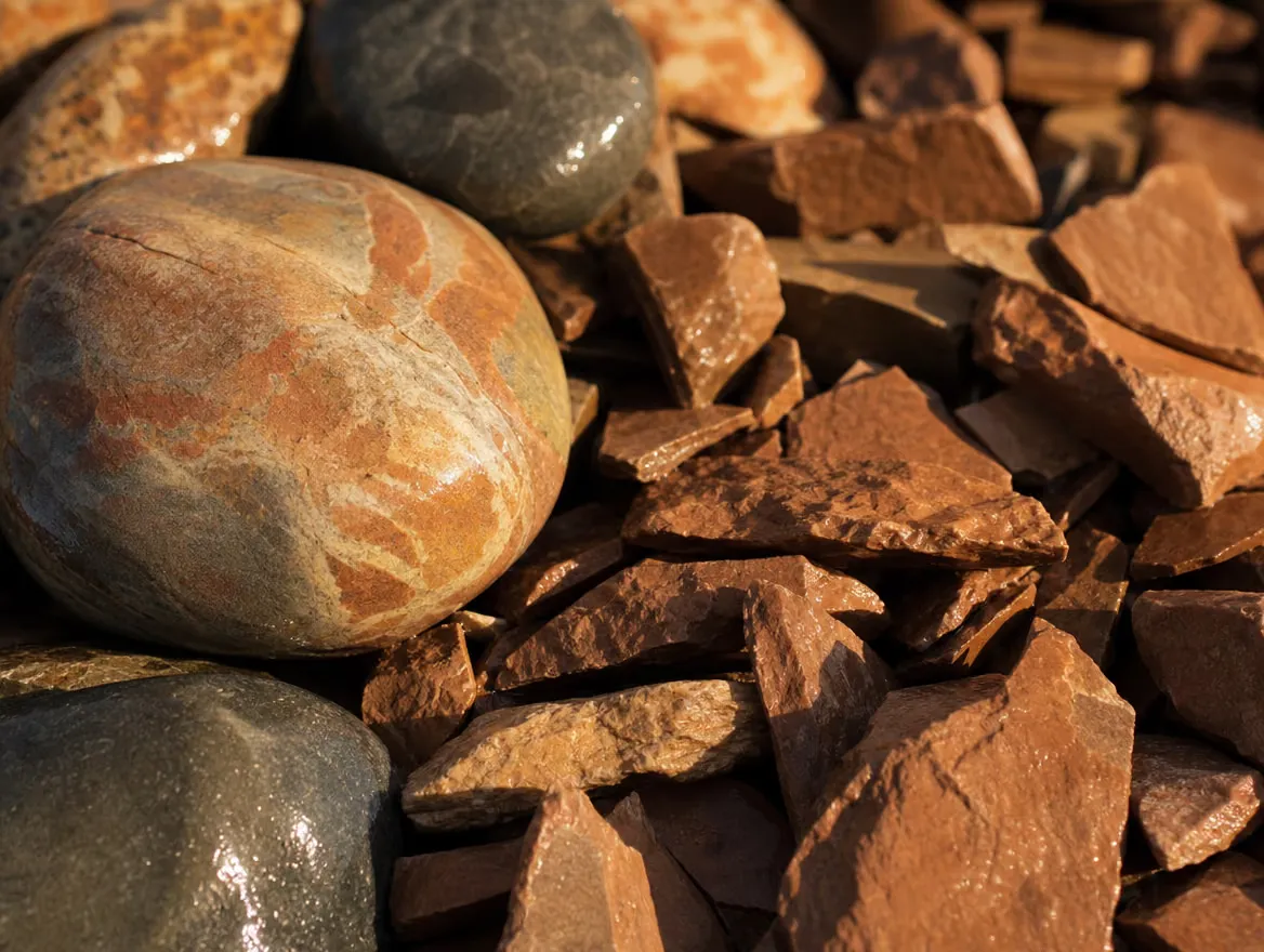 Decorative river rock and terracotta shale chips close up
