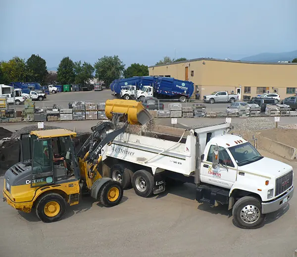 The Vernon Landscape Centre loader filling the delivery truck in the yard on 23 Street